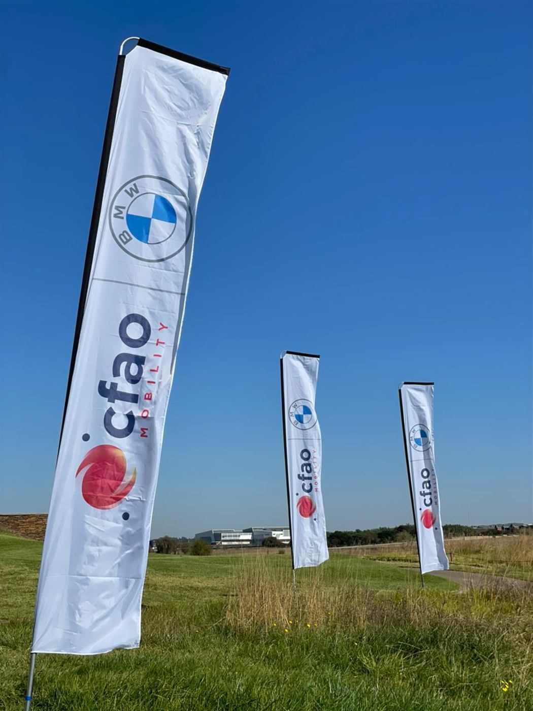 CFAO Mobility and BMW branded feather flags outdoors