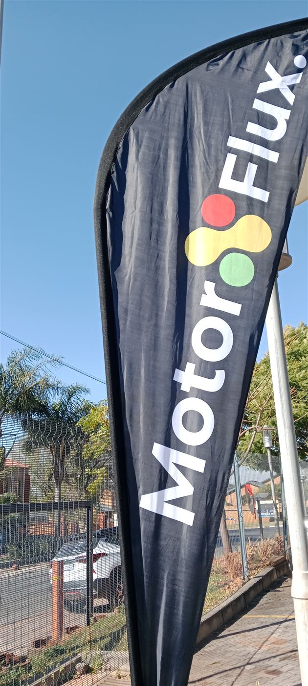 MotorFlux branded feather flag outdoors