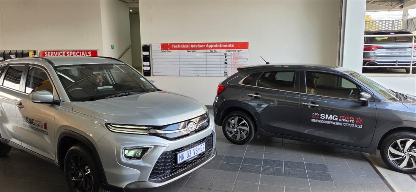 Two SMG Toyota Soweto branded vehicles parked in the dealership service area